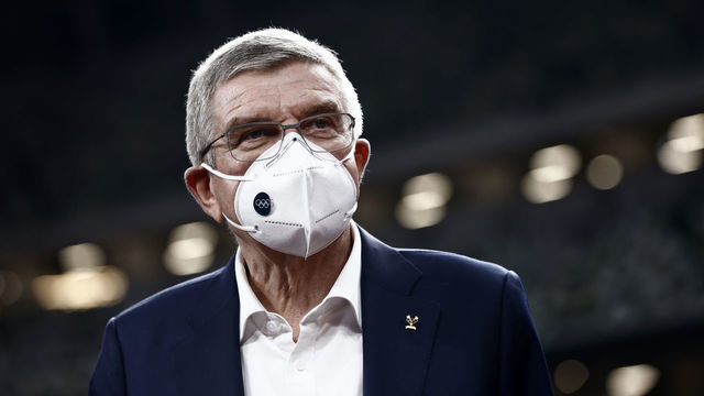 TOKYO, JAPAN - NOVEMBER 17: International Olympic Committee President Thomas Bach, wearing a face mask, speaks to the media during a visit to the National Stadium, main venue for the postponed Tokyo 2020 Olympic and Paralympic Games, on November 17, 2020 in Tokyo, Japan. Mr Bach is making a three-day visit to Tokyo to discuss the 2020 Olympic and Paralympic Games that were postponed because of the Covid-19 coronavirus pandemic. A recently announced vaccine to the virus has raised hope that the Games will go ahead with foreign spectators.