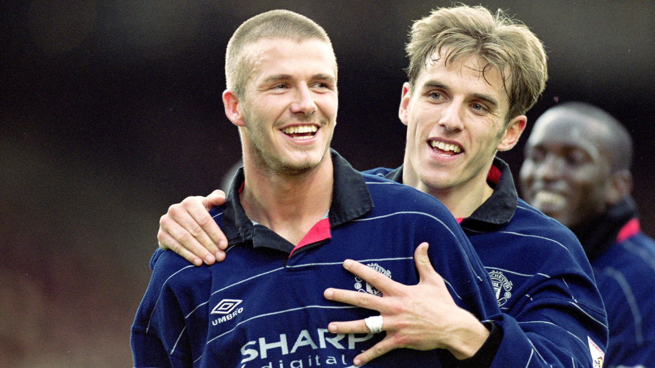 25 Mar 2000: David Beckham of Manchester United is congratulated by teammate Phil Neville during the FA Carling Premiership match against Bradford City at Valley Parade in Bradford, England. Manchester United won the match 4-0. \ Mandatory Credit: Michael Steele/Allsport