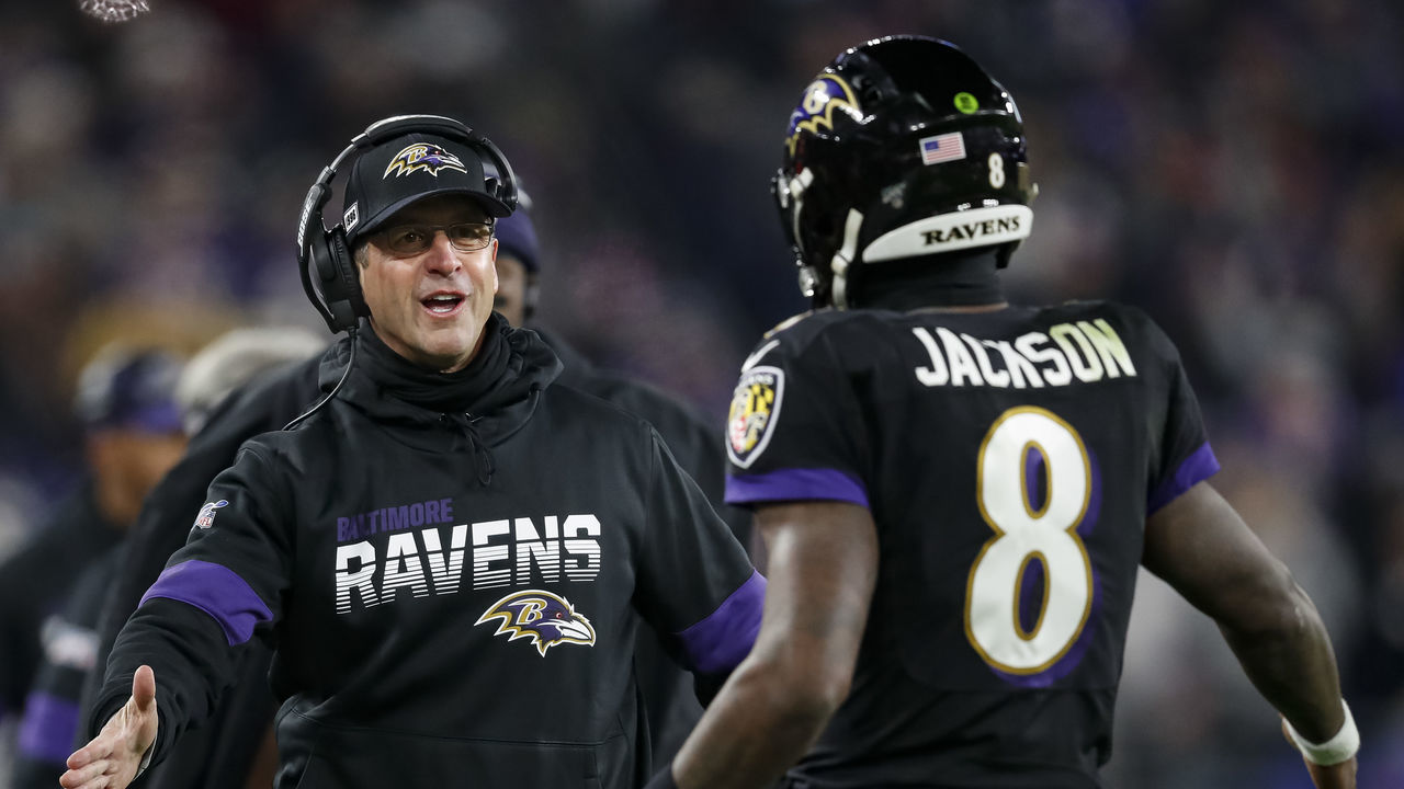 BALTIMORE, MD - DECEMBER 12: Head coach John Harbaugh of the Baltimore Ravens celebrates with Lamar Jackson #8 after a scoring play against the New York Jets during the second half at M&T Bank Stadium on December 12, 2019 in Baltimore, Maryland.