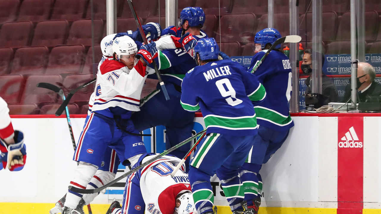 VANCOUVER, BC - JANUARY 21: A skirmish occurs along the boards after a hit by Vancouver Canucks Defenceman Tyler Myers (57) on Montreal Canadiens Right Wing Joel Armia (40) during their NHL game at Rogers Arena on January 21, 2021 in Vancouver, British Columbia, Canada.
