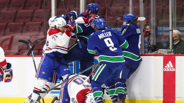 VANCOUVER, BC - JANUARY 21: A skirmish occurs along the boards after a hit by Vancouver Canucks Defenceman Tyler Myers (57) on Montreal Canadiens Right Wing Joel Armia (40) during their NHL game at Rogers Arena on January 21, 2021 in Vancouver, British Columbia, Canada.