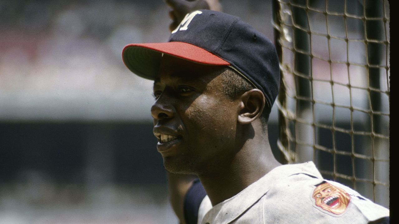 CIRCA 1960's: Outfielder Hank Aaron #44 of the Milwaukee Braves smiling before a circa 1960's Major League Baseball game. Aaron played for the Braves from 1954-74. *** Local Caption ***Hank Aaron
