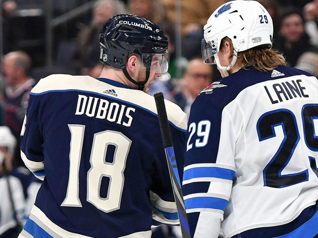 COLUMBUS, OH - JANUARY 22: Pierre-Luc Dubois #18 of the Columbus Blue Jackets talks with Patrik Laine #29 of the Winnipeg Jets during a break in action on January 22, 2020 at Nationwide Arena in Columbus, Ohio.