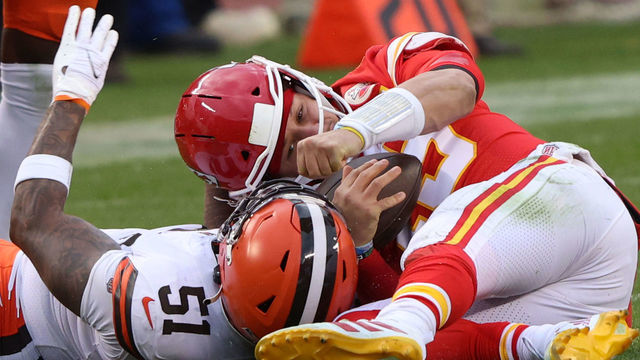 KANSAS CITY, MISSOURI - JANUARY 17: Quarterback Patrick Mahomes #15 of the Kansas City Chiefs is sacked by outside linebacker Mack Wilson #51 of the Cleveland Browns, Mahomes is injured on the play and leaves in the third quarter of the AFC Divisional Playoff game at Arrowhead Stadium on January 17, 2021 in Kansas City, Missouri.