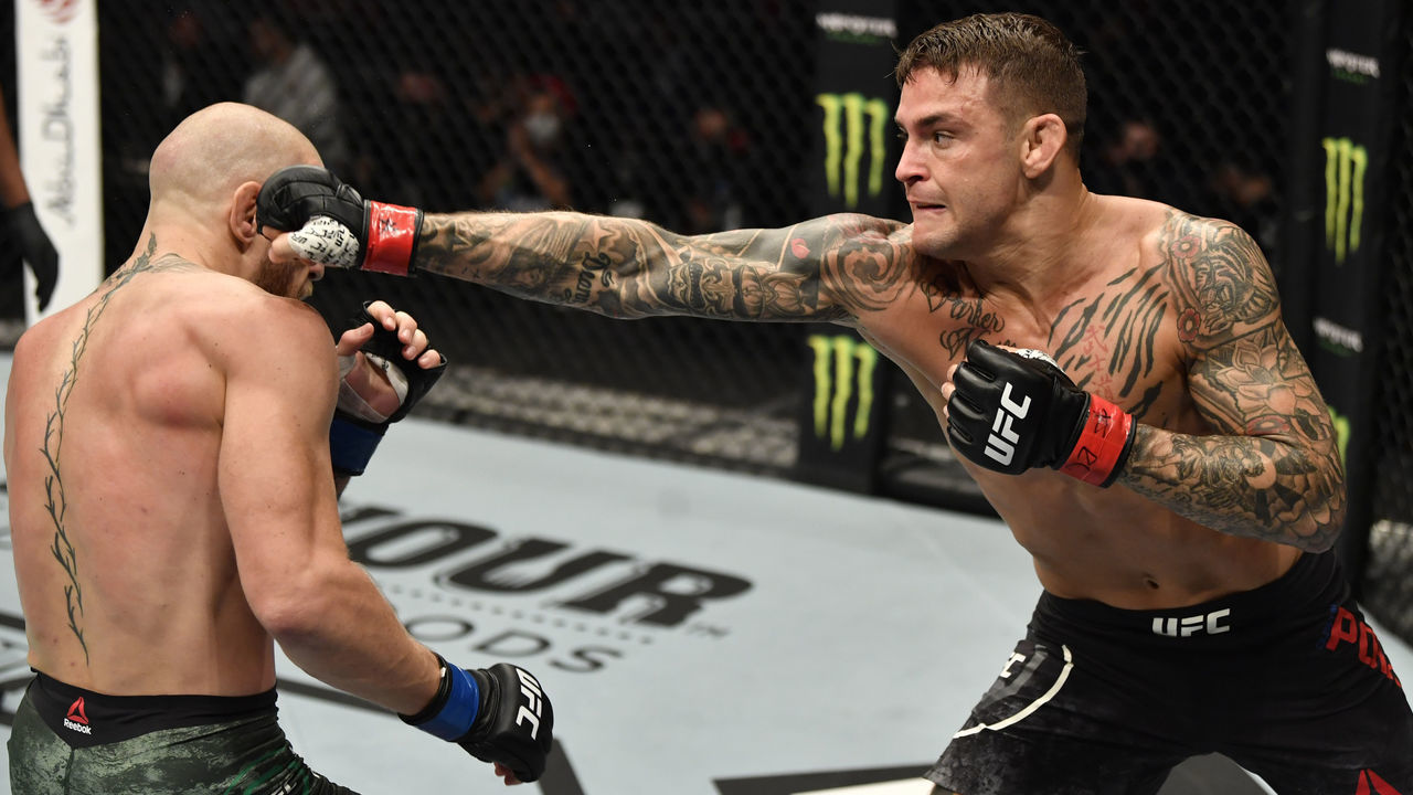 ABU DHABI, UNITED ARAB EMIRATES - JANUARY 23: (R-L) Dustin Poirier punches Conor McGregor of Ireland in a lightweight fight during the UFC 257 event inside Etihad Arena on UFC Fight Island on January 23, 2021 in Abu Dhabi, United Arab Emirates.