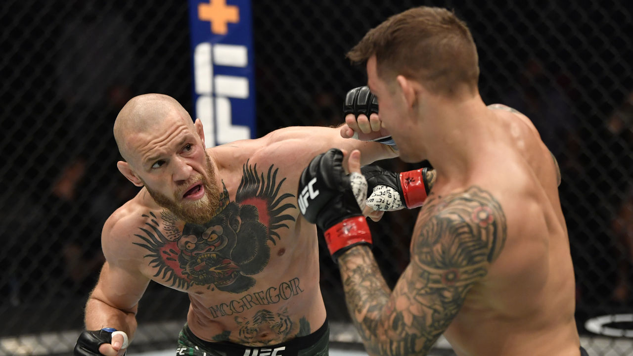 ABU DHABI, UNITED ARAB EMIRATES - JANUARY 23: In this handout image provided by the UFC, (L-R) Conor McGregor of Ireland punches Dustin Poirier in a lightweight fight during the UFC 257 event inside Etihad Arena on UFC Fight Island on January 23, 2021 in Abu Dhabi, United Arab Emirates.