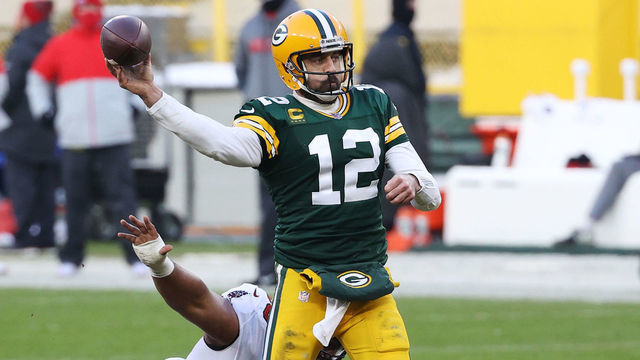 GREEN BAY, WISCONSIN - JANUARY 24: Aaron Rodgers #12 of the Green Bay Packers passes in the third quarter as Vita Vea #50 of the Tampa Bay Buccaneers defends during the NFC Championship game at Lambeau Field on January 24, 2021 in Green Bay, Wisconsin.