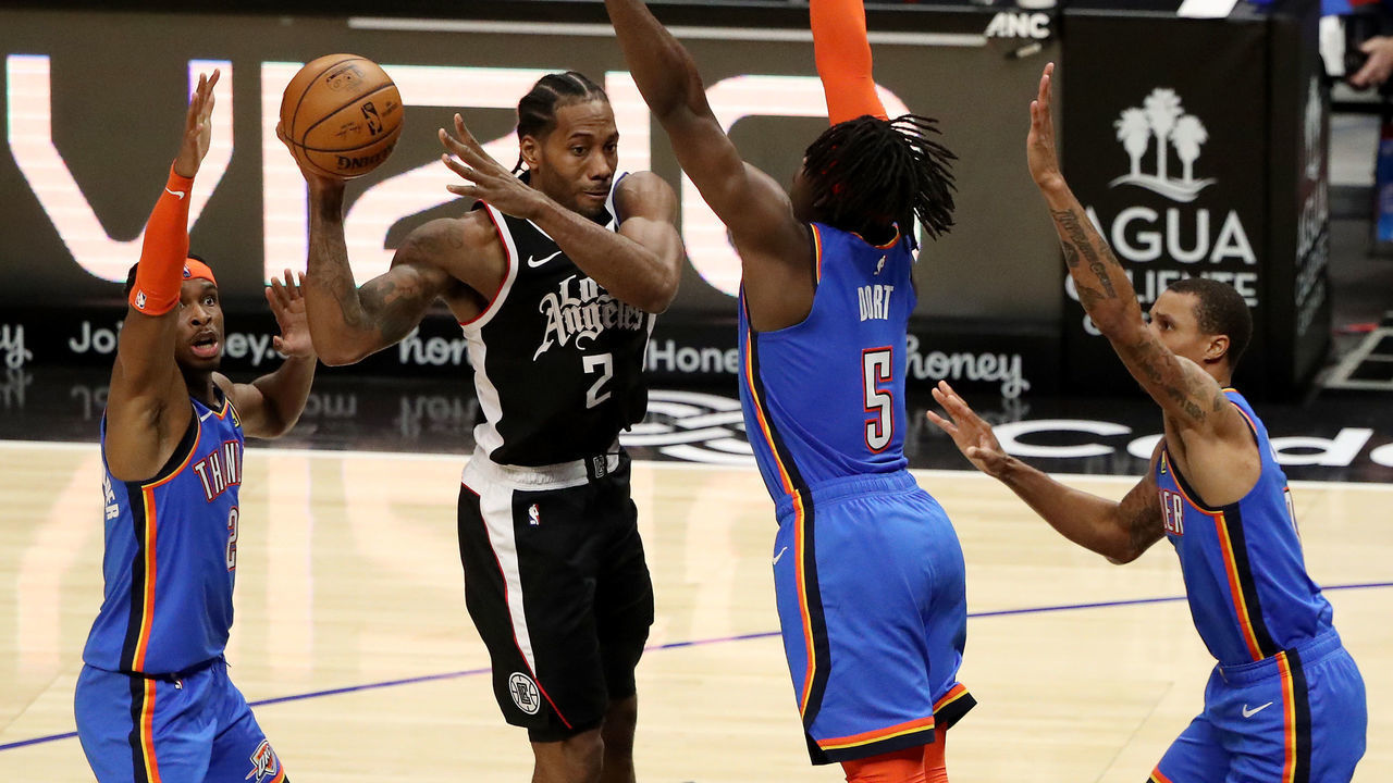 LOS ANGELES, CALIFORNIA - JANUARY 24: Kawhi Leonard #2 of the Los Angeles Clippers looks to pass the ball while defended by Luguentz Dort #5, Shai Gilgeous-Alexander #2 and George Hill #3 of the Oklahoma City Thunder during the fourth quarter at Staples Center on January 24, 2021 in Los Angeles, California.