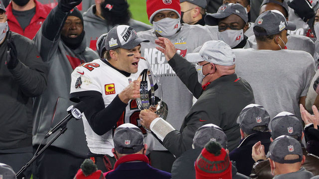 GREEN BAY, WISCONSIN - JANUARY 24: Tom Brady #12 of the Tampa Bay Buccaneers celebrates with head coach Bruce Arians and teammates after their 31 to 26 win over the Green Bay Packers during the NFC Championship game at Lambeau Field on January 24, 2021 in Green Bay, Wisconsin.