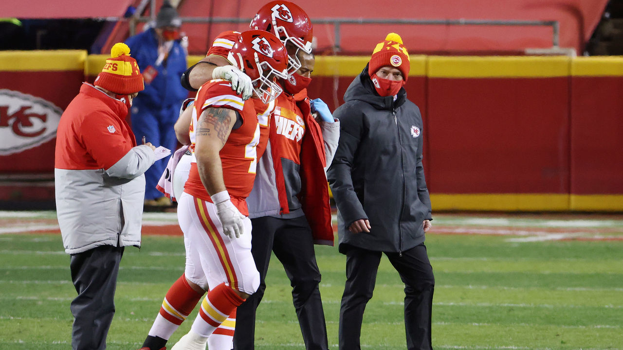 KANSAS CITY, MISSOURI - JANUARY 24: Eric Fisher #72 of the Kansas City Chiefs is helped off the field in the fourth quarter against the Buffalo Bills during the AFC Championship game at Arrowhead Stadium on January 24, 2021 in Kansas City, Missouri.