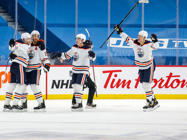 WINNIPEG, MB - JANUARY 24: Leon Draisaitl #29, Darnell Nurse #25, Ryan Nugent-Hopkins #93 and Jesse Puljujarvi #13 of the Edmonton Oilers celebrate a third period goal against the Winnipeg Jets at the Bell MTS Place on January 24, 2021 in Winnipeg, Manitoba, Canada.
