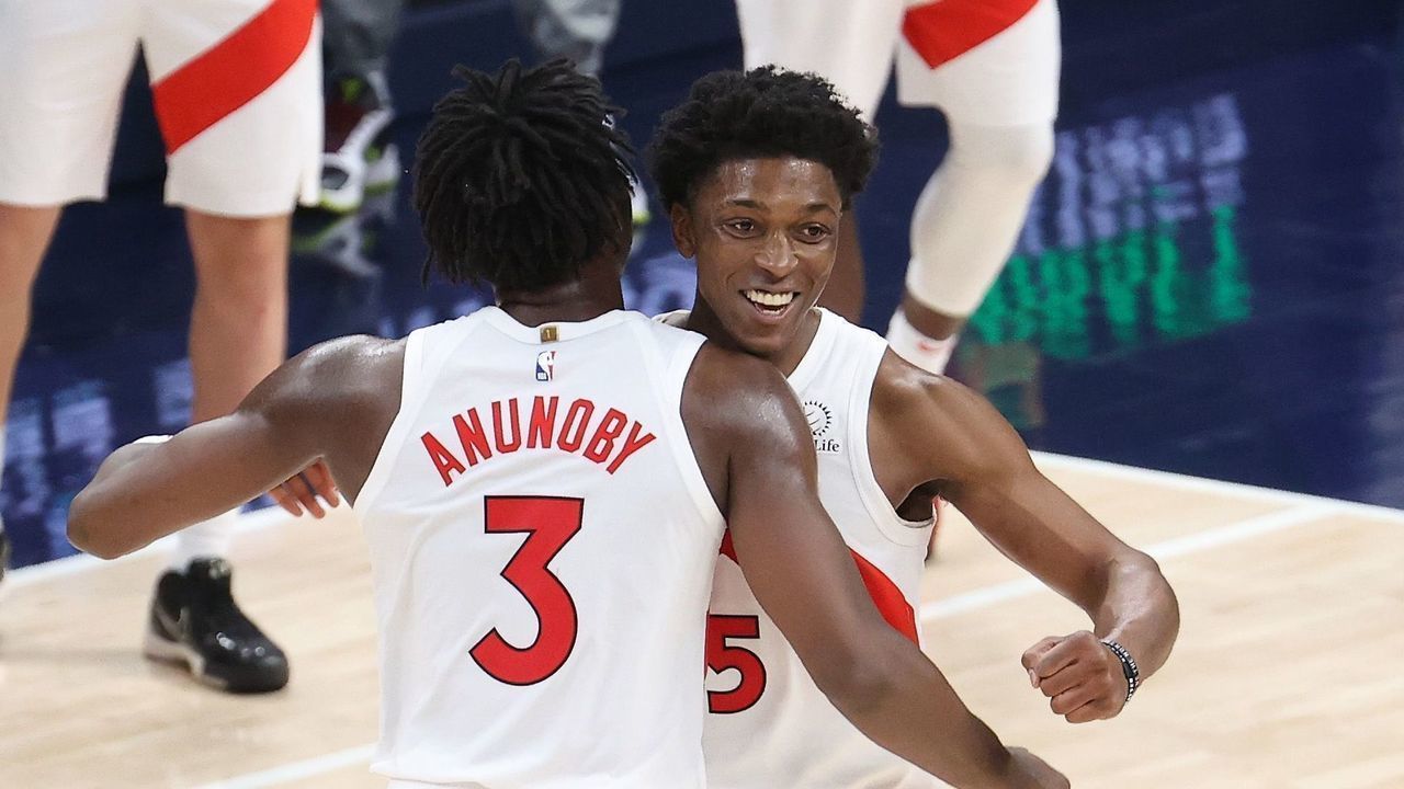 INDIANAPOLIS, INDIANA - JANUARY 24: OG Anunoby #3 and Stanley Johnson #5 of the Toronto Raptors celebrate after the 107-102 win over the Indiana Pacers at Bankers Life Fieldhouse on January 24, 2021 in Indianapolis, Indiana.