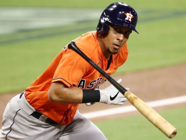 SAN DIEGO, CALIFORNIA - OCTOBER 17: Michael Brantley #23 of the Houston Astros throws his bat while looking at the Tampa Bay Rays dugout while running on a fly out during the third inning in Game Seven of the American League Championship Series at PETCO Park on October 17, 2020 in San Diego, California.