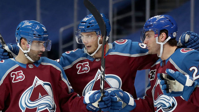 DENVER, COLORADO - JANUARY 26: Nazem Kadri #91 and Andre Burakovsky #95 of the Colorado Avalanche celebrate with Brandon Saad #20 his second goal of the night against the San Jose Sharks in the second period at Ball Arena on January 26, 2021 in Denver, Colorado.
