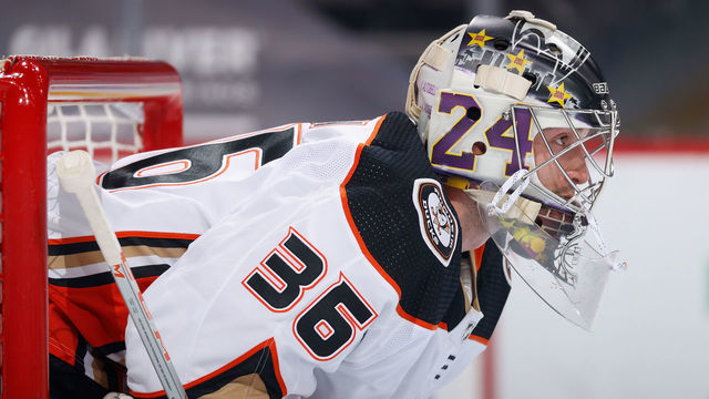 GLENDALE, ARIZONA - JANUARY 26: Goaltender John Gibson #36 of the Anaheim Ducks looks down ice during the first period of the NHL game against the Arizona Coyotes at Gila River Arena on January 26, 2021 in Glendale, Arizona. Gibson is wearing a #24 and #8 on his mask in honor of the late NBA superstar Kobe Bryant of the Los Angeles Lakers.
