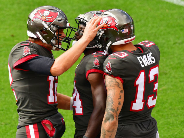 CO - SEPTEMBER 27 : From left, Tampa Bay Buccaneers QB Tom Brady (12), WRChris Godwin (14) and WR Mike Evans celebrate Godwin's first touch down of the game against Denver Broncos at Empower Field at Mile High in Denver, Colorado on Sunday. September 27, 2020.
