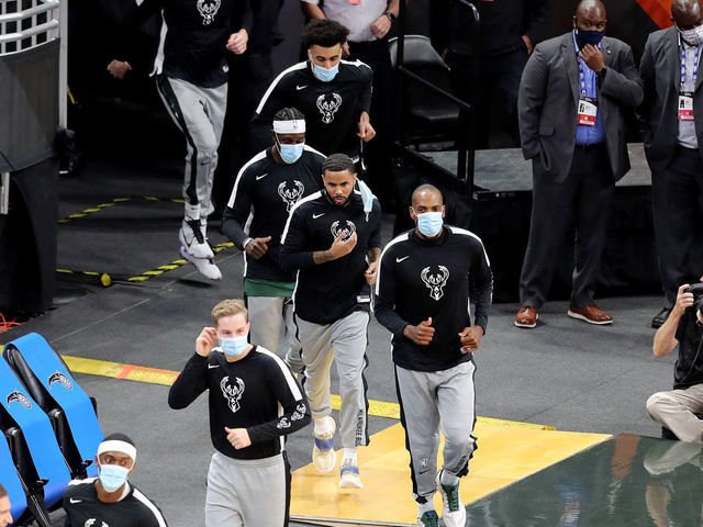 ORLANDO, FL - JANUARY 11: Masked Milwaukee Bucks players enter the court against the Orlando Magic at Amway Center on January 11, 2021 in Orlando, Florida.