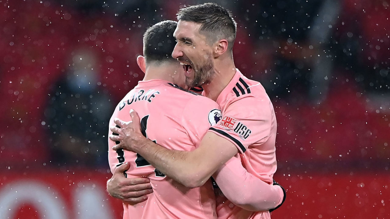 Sheffield United's Oliver Burke (left) celebrates with Chris Basham after scoring their side's second goal of the game during the Premier League match at Old Trafford, Manchester. Picture date: Wednesday January 27, 2021.