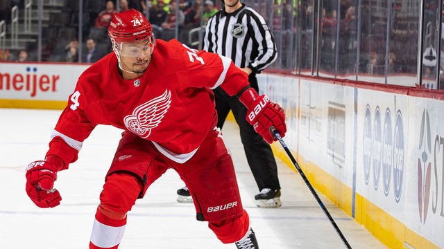 DETROIT, MI - FEBRUARY 25: Madison Bowey #74 of the Detroit Red Wings skates up ice with the puck against the New Jersey Devils during an NHL game at Little Caesars Arena on February 25, 2020 in Detroit, Michigan. The Devils defeated the Wings 4-1.