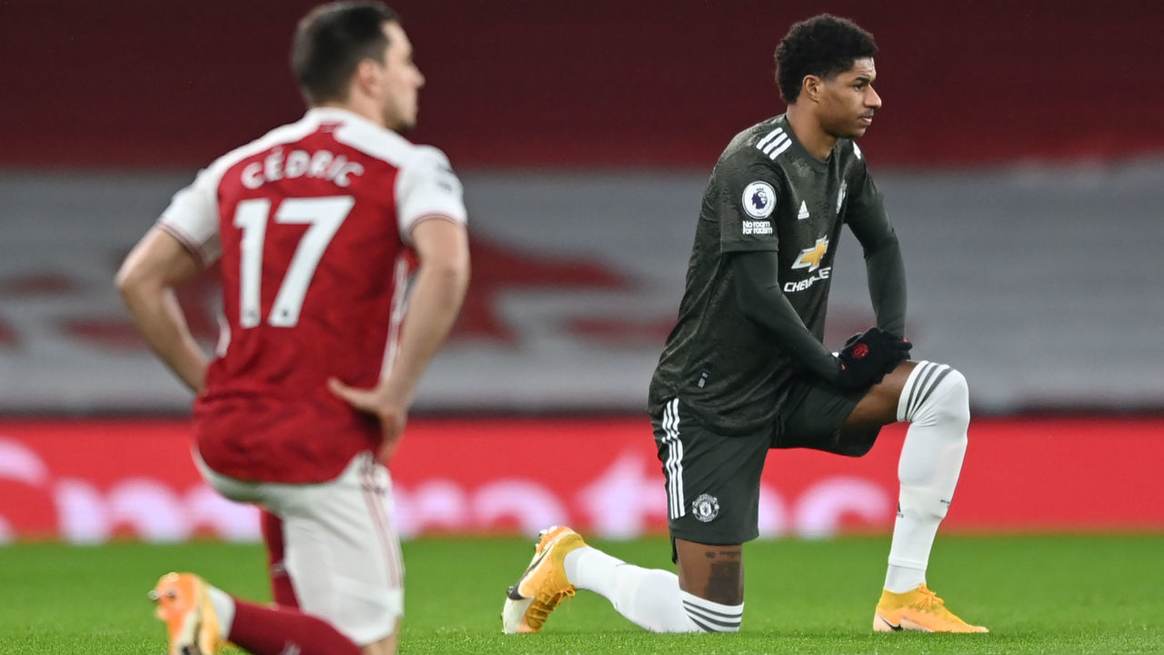 Manchester United's English striker Marcus Rashford (R) 'takes a knee' in support of the No Room For Racism campaign ahead of the English Premier League football match between Arsenal and Manchester United at the Emirates Stadium in London on January 30, 2021.