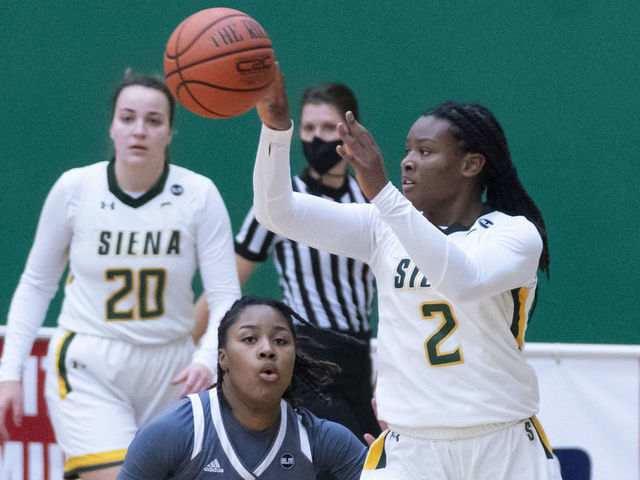 LOUDONVILLE, NY - JANUARY 09: Siena Saints Guard Amari Anthony (2) passes the ball with Rider Broncs Guard Lenaejha Evans (20) defending during the second half of the Womens College Basketball game between the Rider Broncs and the Siena Saints on January 9, 2021, at Alumni Recreation Center in Loudonville, NY.