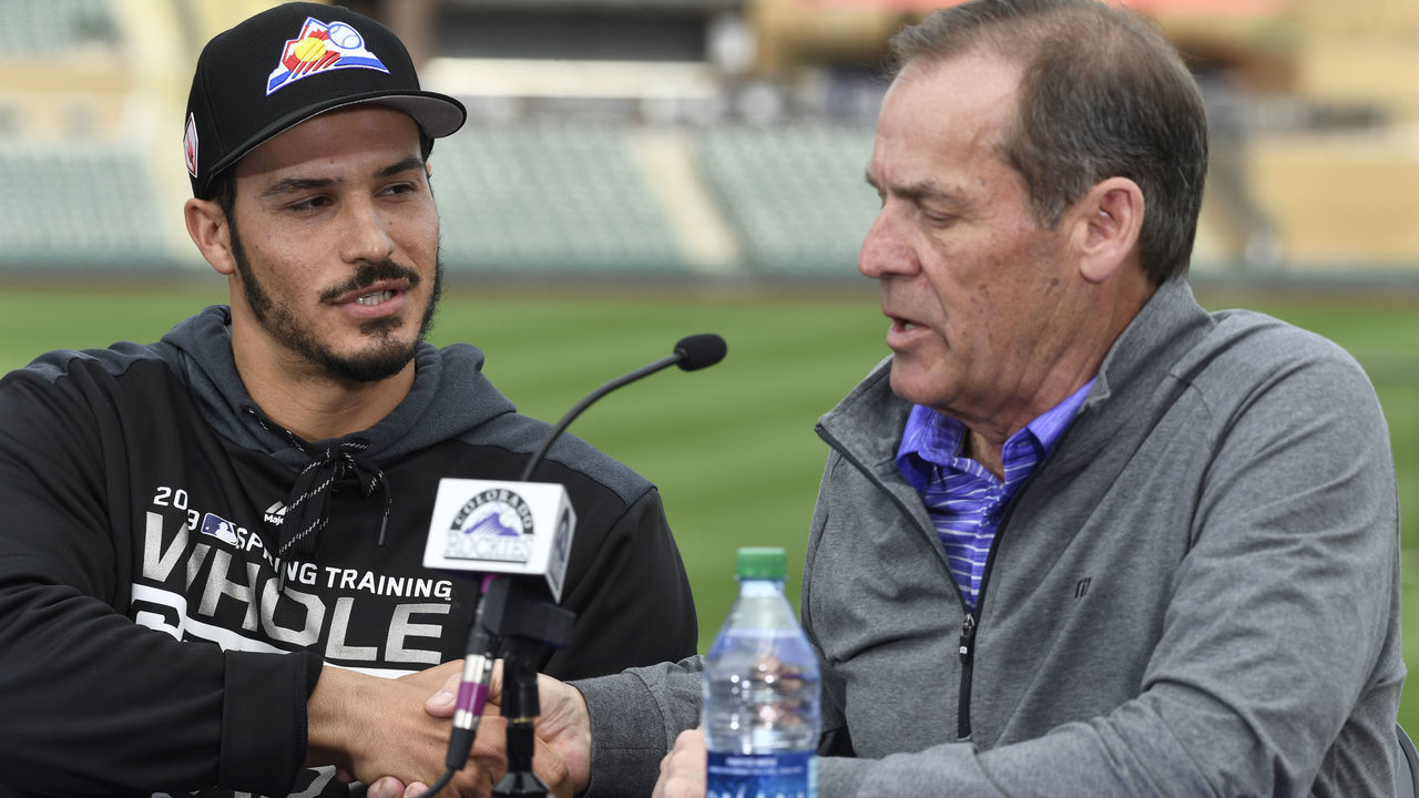 SCOTTSDALE, AZ - FEBRUARY 27: Colorado Rockies third baseman Nolan Arenado (28) shakes hands with Rockies owner Dick Monfort at Salt River Fields February 27, 2019. The Colorado Rockies and Arenado signed a 8-year, $260 million dollar deal, largest in franchise history, with a opt-out clause after three years.