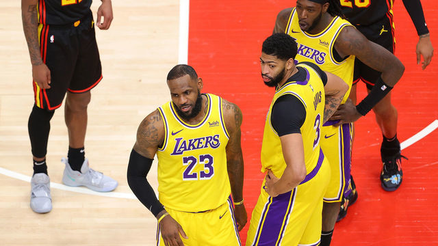 ATLANTA, GEORGIA - FEBRUARY 01: LeBron James #23 of the Los Angeles Lakers reacts to a fan courtside during the second half against the Atlanta Hawks at State Farm Arena on February 01, 2021 in Atlanta, Georgia.