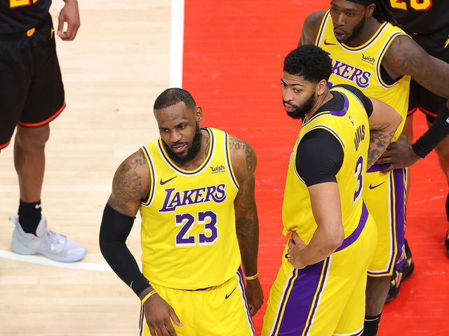 ATLANTA, GEORGIA - FEBRUARY 01: LeBron James #23 of the Los Angeles Lakers reacts to a fan courtside during the second half against the Atlanta Hawks at State Farm Arena on February 01, 2021 in Atlanta, Georgia.