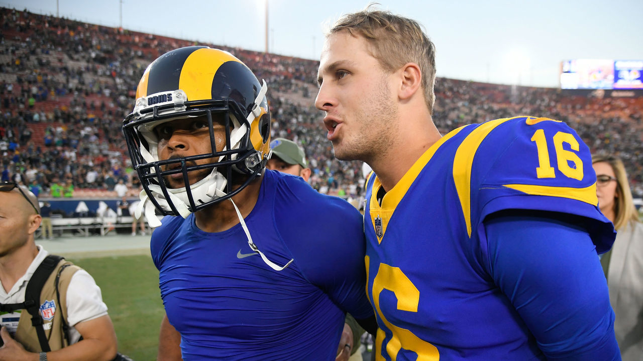 LOS ANGELES, CA - NOVEMBER 11: Quarterback Jared Goff #16 and defensive end Aaron Donald #99 of the Los Angeles Rams walk off the field after winning 36-31 against the Seattle Seahawks at Los Angeles Memorial Coliseum on November 11, 2018 in Los Angeles, California.