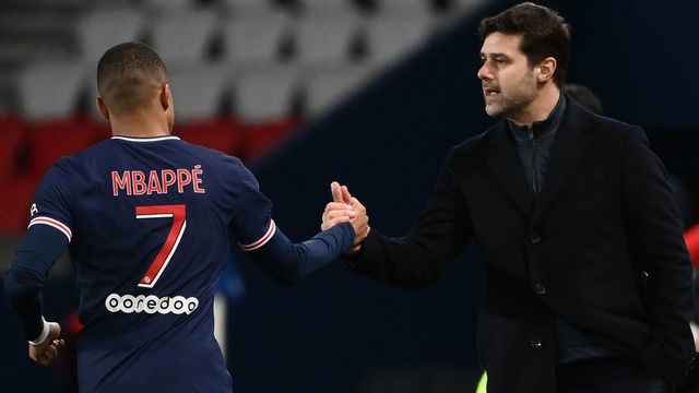 Paris Saint-Germain's French forward Kylian Mbappe (L) celebrates after scoring a goal with Paris Saint-Germain's Argentine head coach Mauricio Pochettino during the French L1 football match between Paris Saint-Germain and Nimes Olympique at the Parc des Princes stadium in Paris on February 3, 2020.