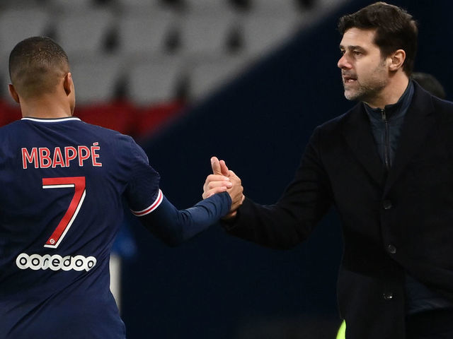 Paris Saint-Germain's French forward Kylian Mbappe (L) celebrates after scoring a goal with Paris Saint-Germain's Argentine head coach Mauricio Pochettino during the French L1 football match between Paris Saint-Germain and Nimes Olympique at the Parc des Princes stadium in Paris on February 3, 2020.