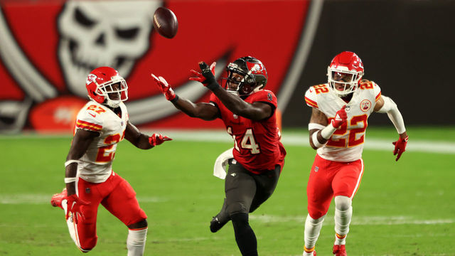TAMPA, FLORIDA - NOVEMBER 29: Chris Godwin #14 of the Tampa Bay Buccaneers attempts to make a catch in the third quarter against Juan Thornhill #22 and Rashad Fenton #27 of the Kansas City Chiefs during their game at Raymond James Stadium on November 29, 2020 in Tampa, Florida.