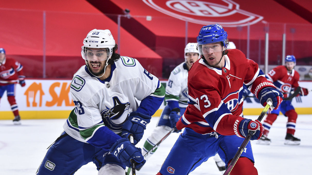 MONTREAL, QC - FEBRUARY 02: Jalen Chatfield #63 of the Vancouver Canucks and Tyler Toffoli #73 of the Montreal Canadiens skate against each other during the second period at the Bell Centre on February 2, 2021 in Montreal, Canada.
