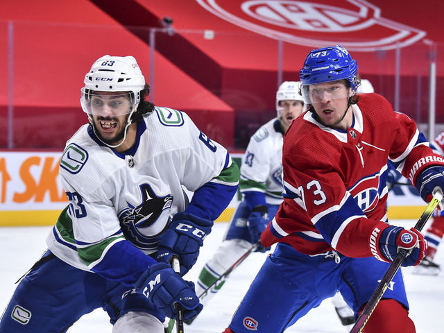 MONTREAL, QC - FEBRUARY 02: Jalen Chatfield #63 of the Vancouver Canucks and Tyler Toffoli #73 of the Montreal Canadiens skate against each other during the second period at the Bell Centre on February 2, 2021 in Montreal, Canada.