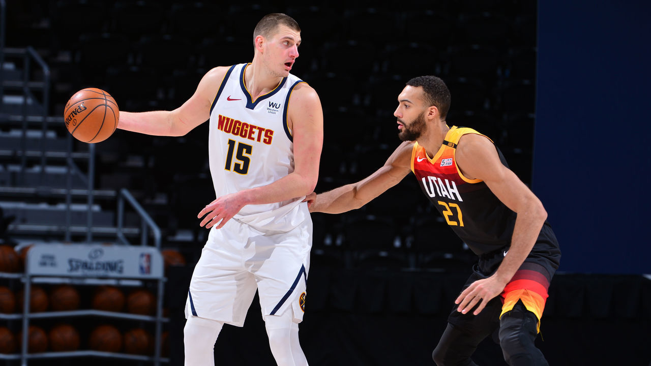 DENVER, CO - JANUARY 31: Nikola Jokic #15 of the Denver Nuggets handles the ball against Rudy Gobert #27 of the Utah Jazz on January 31, 2021 at the Ball Arena in Denver, Colorado. NOTE TO USER: User expressly acknowledges and agrees that, by downloading and/or using this Photograph, user is consenting to the terms and conditions of the Getty Images License Agreement. Mandatory Copyright Notice: Copyright 2021 NBAE