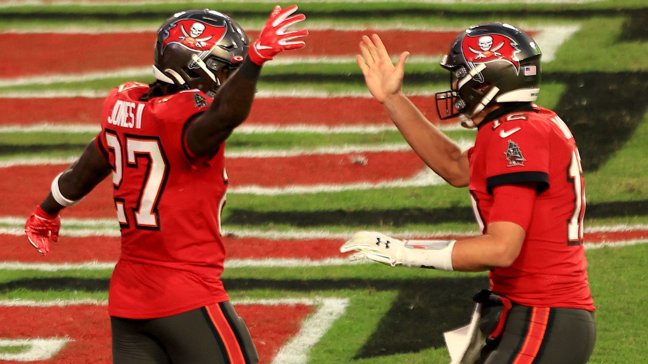 TAMPA, FLORIDA - NOVEMBER 29: Ronald Jones II #27 of the Tampa Bay Buccaneers celebrates with teammate Tom Brady #12 following a touchdown catch in the second quarter during their game against the Kansas City Chiefs at Raymond James Stadium on November 29, 2020 in Tampa, Florida.