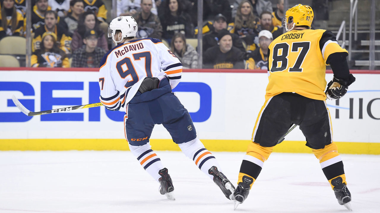 PITTSBURGH, PA - FEBRUARY 13: Edmonton Oilers Center Connor McDavid (97) and Pittsburgh Penguins Center Sidney Crosby (87) skate during the first period in the NHL game between the Pittsburgh Penguins and the Edmonton Oilers on February 13, 2019, at PPG Paints Arena in Pittsburgh, PA.