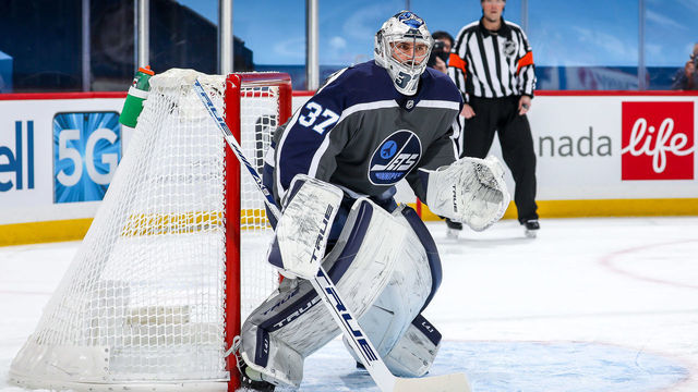 WINNIPEG, MB - FEBRUARY 4: Goaltender Connor Hellebuyck #37 of the Winnipeg Jets guards the net during first period action against the Calgary Flames at the Bell MTS Place on February 4, 2021 in Winnipeg, Manitoba, Canada.