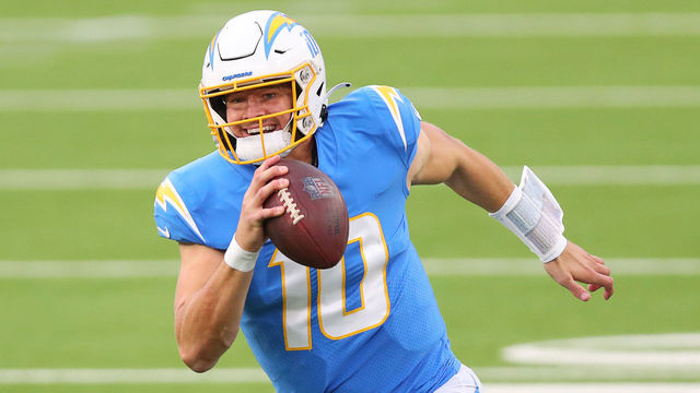 INGLEWOOD, CALIFORNIA - DECEMBER 27: Justin Herbert #10 of the Los Angeles Chargers runs the ball in the third quarter against the Denver Broncos at SoFi Stadium on December 27, 2020 in Inglewood, California.