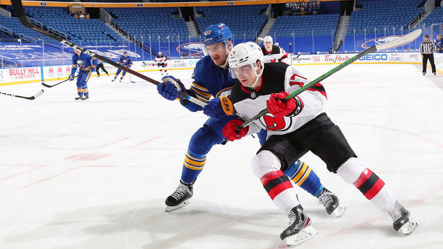 BUFFALO, NY - JANUARY 31: Yegor Sharangovich #17 of the New Jersey Devils skates during an NHL game against Colin Miller #33 of the Buffalo Sabres on January 31, 2021 at KeyBank Center in Buffalo, New York. New Jersey won, 5-3.