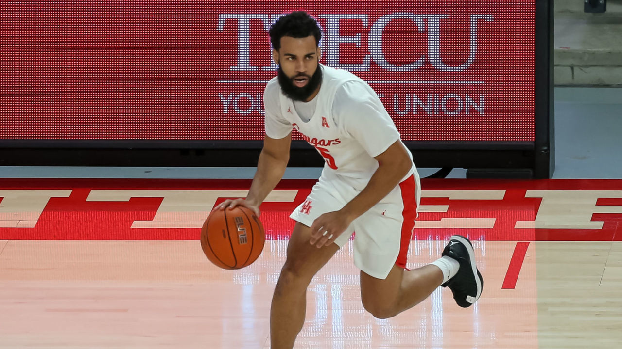HOUSTON, TX - JANUARY 31: Houston Cougars guard Cameron Tyson (5) dribbles the ball during the college basketball game between the Southern Methodist Mustangs and Houston Cougars on January 31, 2021 at Fertitta Center in Houston, Texas.