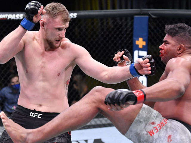 LAS VEGAS, NEVADA - FEBRUARY 06: (L-R) Alexander Volkov of Russia punches Alistair Overeem of the Netherlands in their heavyweight fight during the UFC Fight Night event at UFC APEX on February 06, 2021 in Las Vegas, Nevada.