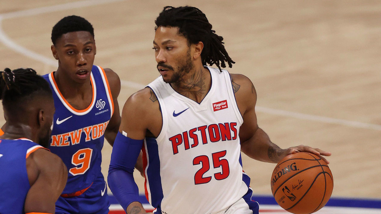 DETROIT, MICHIGAN - DECEMBER 11: Derrick Rose #25 of the Detroit Pistons controls the ball in front of RJ Barrett #9 of the New York Knicks during the second half at Little Caesars Arena on December 11, 2020 in Detroit, Michigan.
