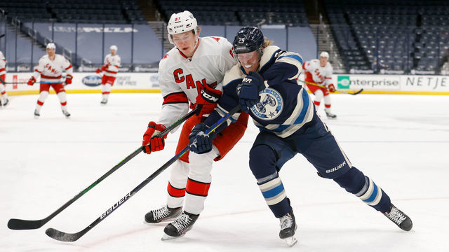 COLUMBUS, OH - FEBRUARY 7: Morgan Geekie #67 of the Carolina Hurricanes and Patrick Laine #29 of the Columbus Blue Jackets battle for control of the puck during the first period of the game at Nationwide Arena on February 7, 2021 in Columbus, Ohio.