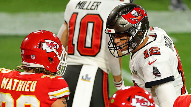 TAMPA, FLORIDA - FEBRUARY 07: Tom Brady #12 of the Tampa Bay Buccaneers speaks to Tyrann Mathieu #32 of the Kansas City Chiefs during the second quarter in Super Bowl LV at Raymond James Stadium on February 07, 2021 in Tampa, Florida.
