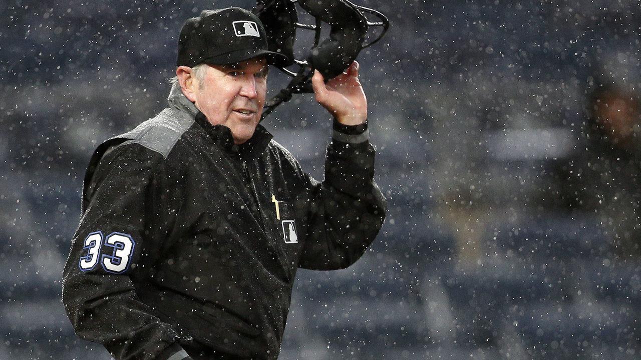 NEW YORK, NY - MAY 5: Umpire Mike Winters #33 takes off his mask as he gets set to signal that he is stopping the game in the heavy rain after a wild pitch during the 8th inning in an MLB baseball game on May 5, 2019 at Yankee Stadium in the Bronx borough of New York City. Yankees won 4-1.