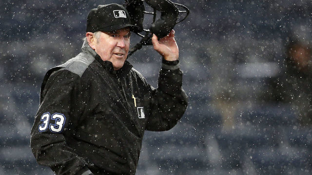 NEW YORK, NY - MAY 5: Umpire Mike Winters #33 takes off his mask as he gets set to signal that he is stopping the game in the heavy rain after a wild pitch during the 8th inning in an MLB baseball game on May 5, 2019 at Yankee Stadium in the Bronx borough of New York City. Yankees won 4-1.
