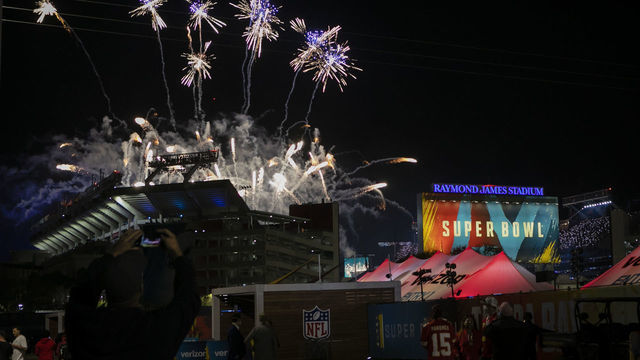 FLORIDA, USA - FEBRUARY 07: Fans watch fireworks as they gather outside Raymond James Stadium during Super Bowl LV, in Tampa, Florida, United States on February 07, 2021.