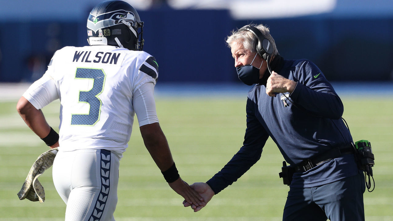 ORCHARD PARK, NEW YORK - NOVEMBER 08: Russell Wilson #3 high-fives head coach Pete Carroll of the Seattle Seahawks during the first half against the Buffalo Bills at Bills Stadium on November 08, 2020 in Orchard Park, New York.