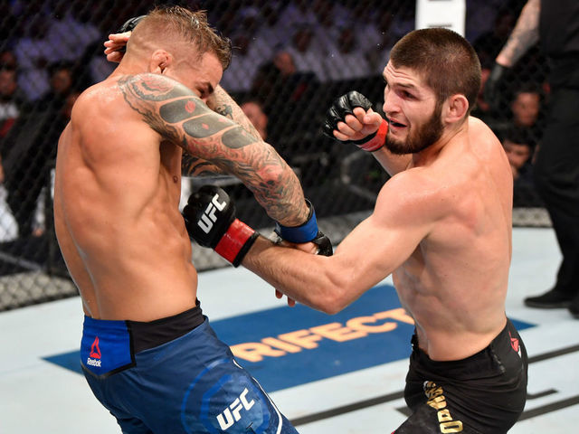 ABU DHABI, UNITED ARAB EMIRATES - SEPTEMBER 07: (R-L) Khabib Nurmagomedov of Russia punches Dustin Poirier in their lightweight championship bout during UFC 242 at The Arena on September 7, 2019 in Yas Island, Abu Dhabi, United Arab Emirates.